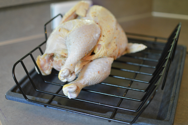 Place chicken on rack, wing side up. Roast 20 minutes, then rotate chicken, other wing side up. Roast 20 minutes, then rotate chicken, breast side up.